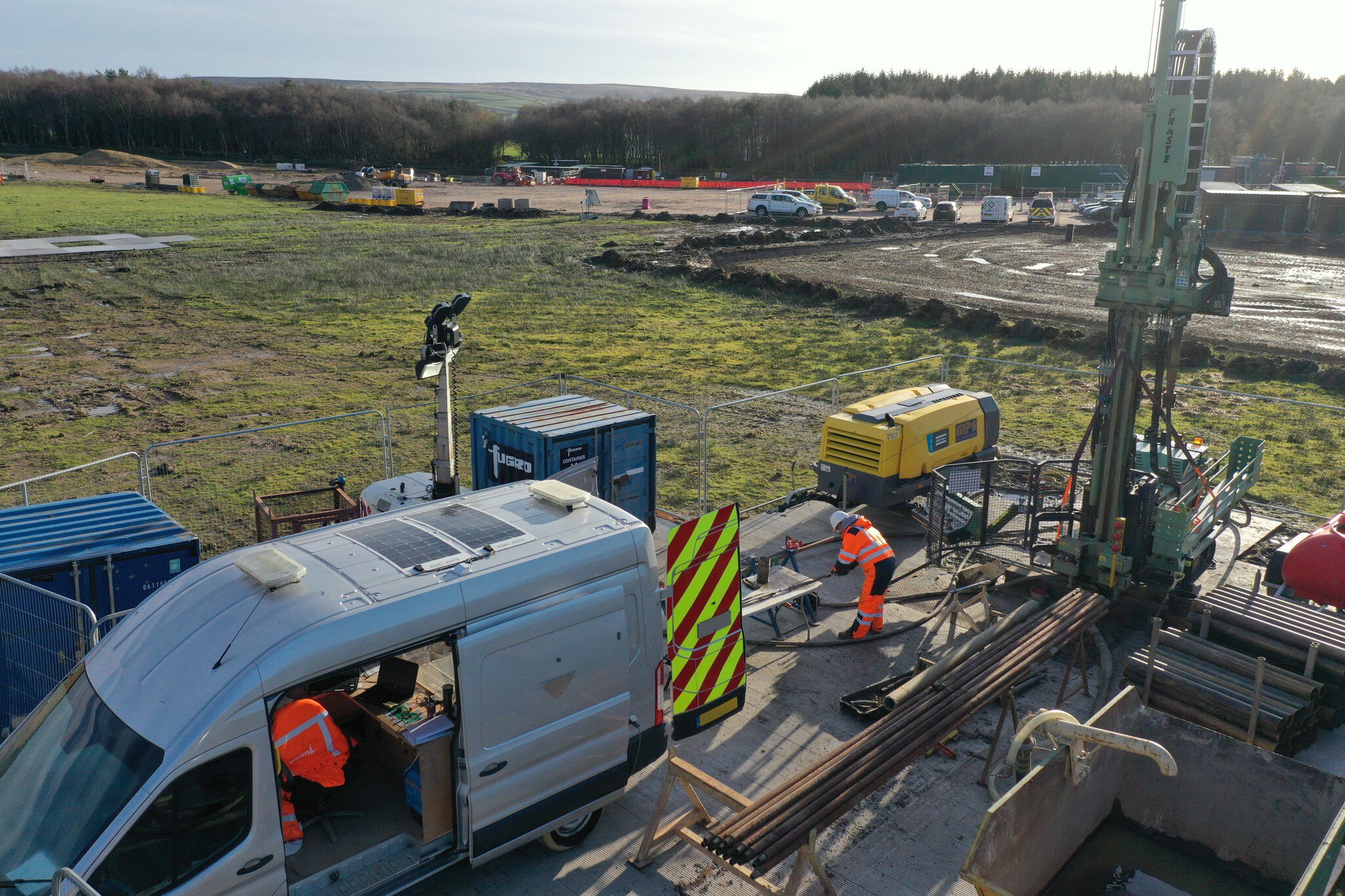 Side view of reduced-emission mobile wireline geophysics logging unit on site in UK
