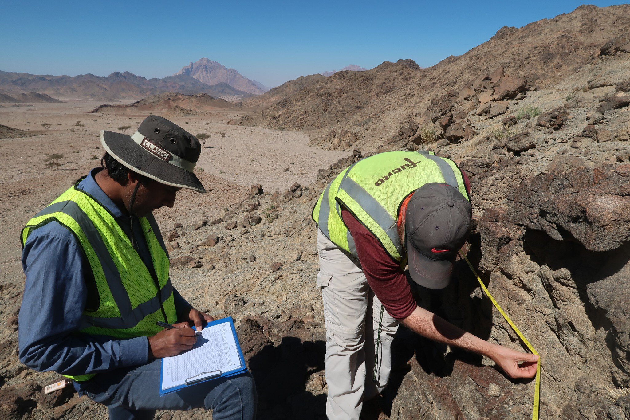 Scanline survey (geologic mapping) for proposed Adit 3 location between Sharmaa and Shigry, Kingdom of Saudi Arabia for the NEOM Mountain Phase 2 project.
Scanline survey (geologic mapping) for proposed Adit 3 location between Sharmaa and Shigry, Kingdom of Saudi Arabia for the NEOM Mountain Phase 2 project.
Field geologist,  James edit,  NEOM Mountain Geo Studies,  Saudi Arabia,  geological and geophysical surveys,  geological mapping,  hero,  outcrop mapping,  scanline survey,  Apparel,  Clothing,  Human,  Person,  Soil