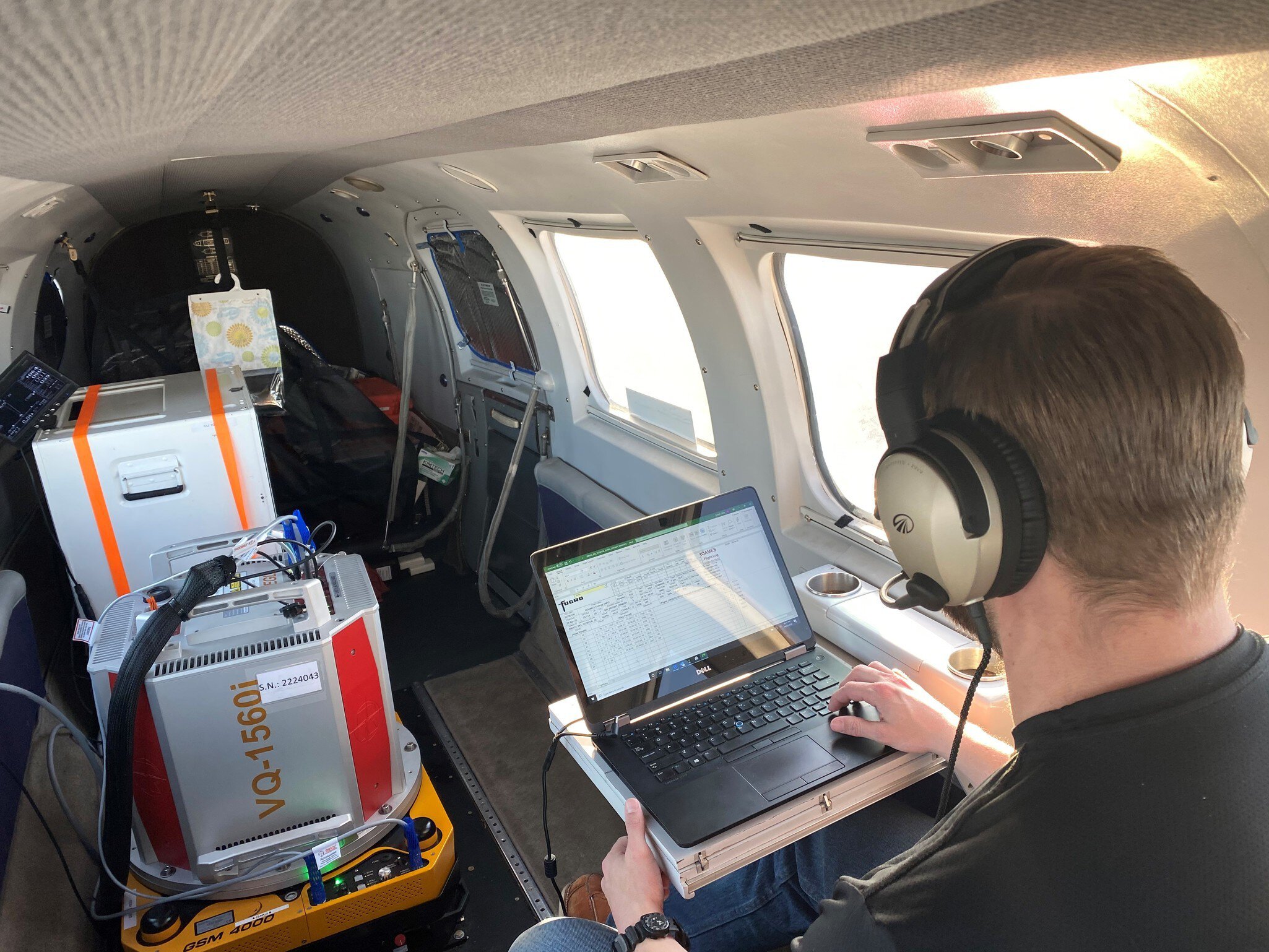 Imagery sensor operator in aeroplane during remote data acquisition